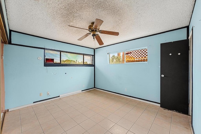 empty room with crown molding, light tile patterned floors, a textured ceiling, and ceiling fan