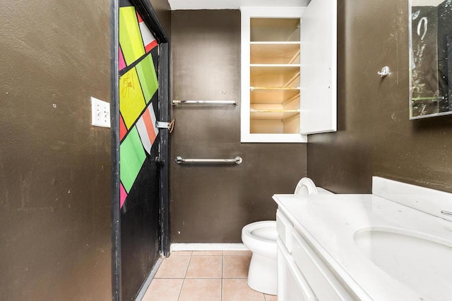 bathroom featuring tile patterned flooring, vanity, and toilet