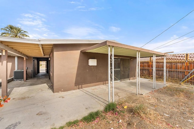 exterior space with cooling unit and a patio area