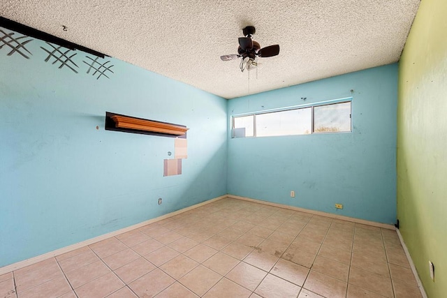 unfurnished room featuring light tile patterned floors, a textured ceiling, and ceiling fan