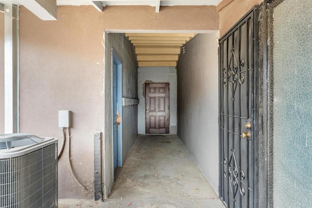 view of exterior entry featuring central air condition unit