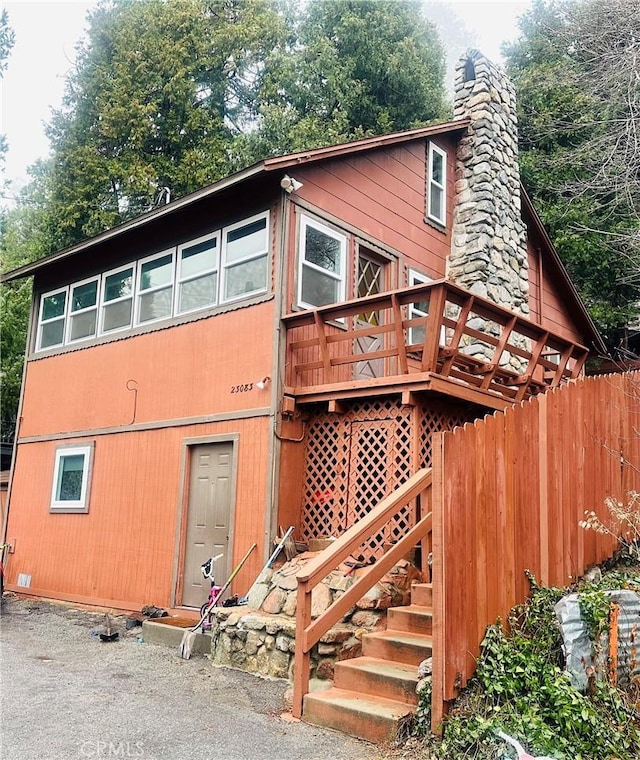 back of house with a wooden deck