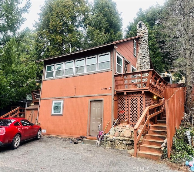 back of house with a wooden deck