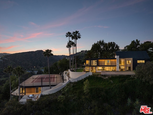 back house at dusk with a mountain view