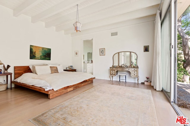 bedroom featuring connected bathroom, hardwood / wood-style floors, beam ceiling, and access to outside