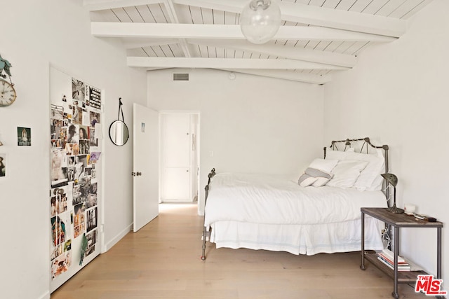 bedroom with vaulted ceiling with beams, light hardwood / wood-style flooring, and wooden ceiling