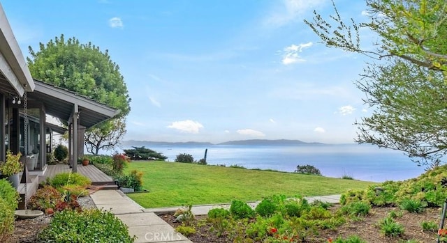 view of yard featuring a deck with water view