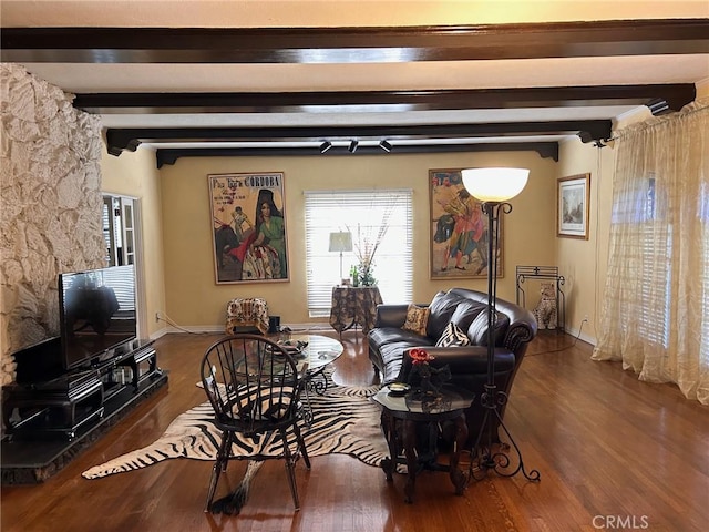 living room with beamed ceiling and hardwood / wood-style floors