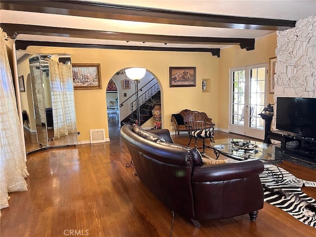 living room featuring hardwood / wood-style flooring, french doors, and beamed ceiling