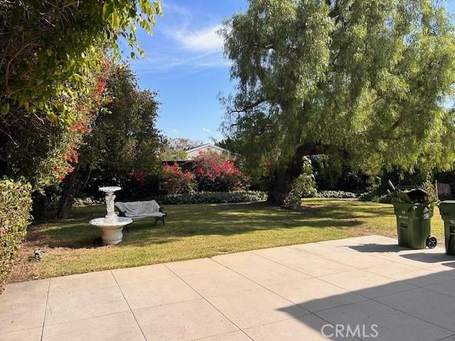 view of community featuring a yard and a patio