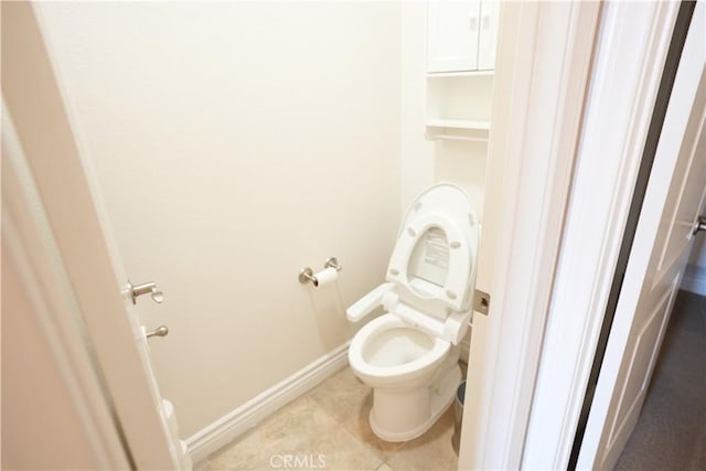 bathroom featuring tile patterned flooring and toilet