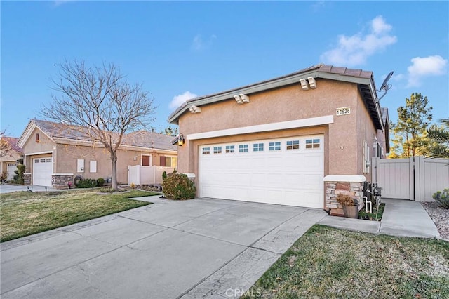 view of front of house with a garage and a front lawn