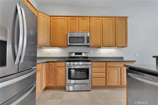 kitchen with appliances with stainless steel finishes and light tile patterned floors