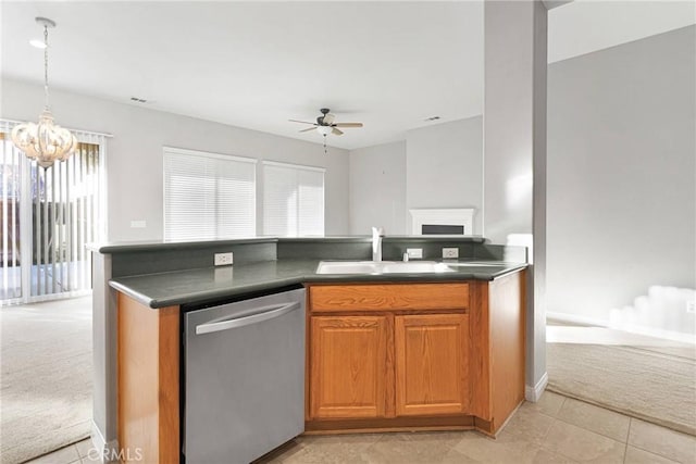 kitchen featuring ceiling fan with notable chandelier, pendant lighting, sink, stainless steel dishwasher, and light carpet