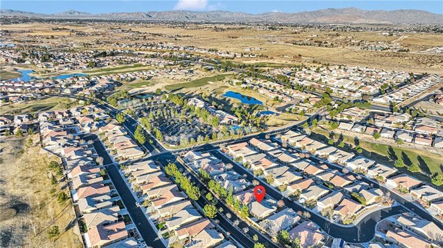 drone / aerial view with a water and mountain view