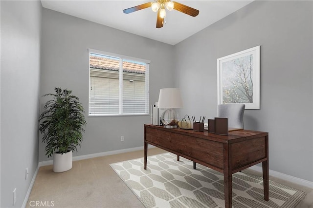 carpeted office space featuring ceiling fan