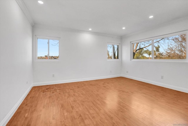 empty room with ornamental molding and hardwood / wood-style floors