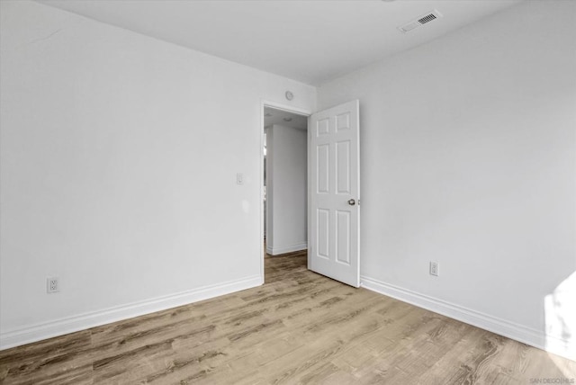 spare room featuring light hardwood / wood-style flooring