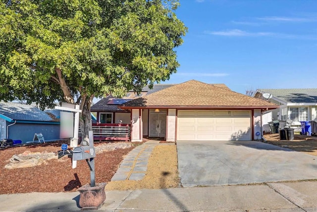 single story home featuring a garage and solar panels