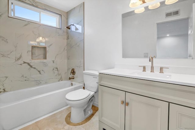 full bathroom featuring tiled shower / bath, vanity, and toilet