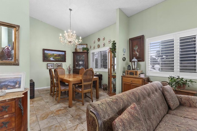 dining space with a chandelier and vaulted ceiling