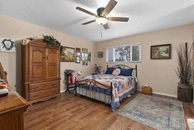 bedroom with hardwood / wood-style floors and ceiling fan