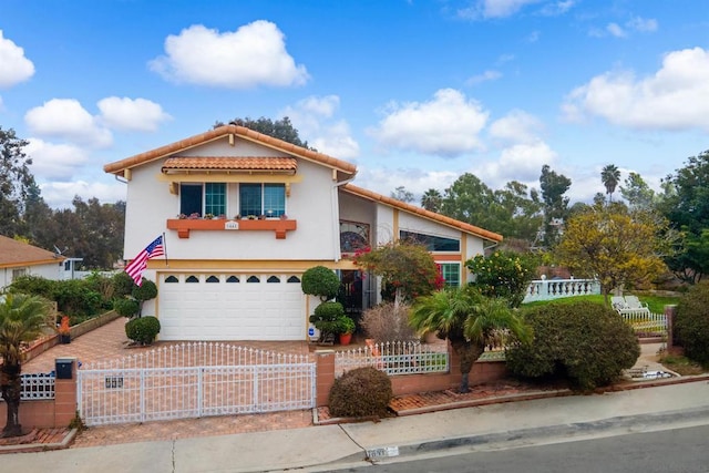 mediterranean / spanish home with a garage