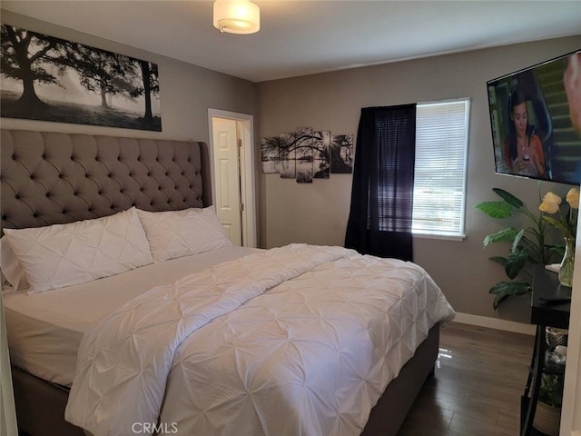 bedroom with dark wood-type flooring