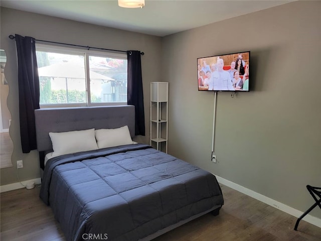 bedroom with hardwood / wood-style flooring