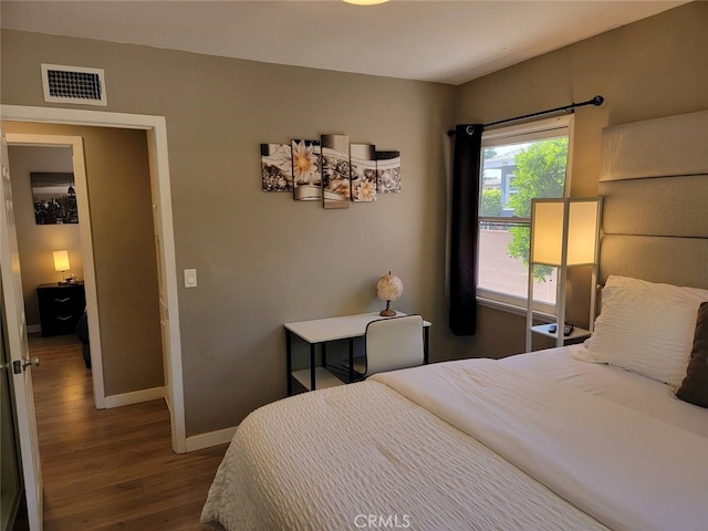 bedroom with dark hardwood / wood-style flooring