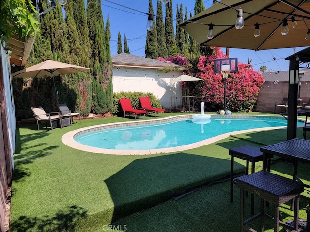 view of pool with a lawn