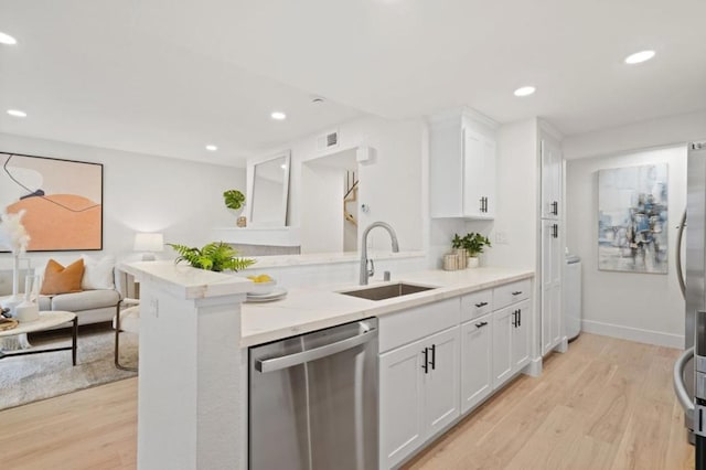 kitchen with white cabinetry, sink, kitchen peninsula, and dishwasher