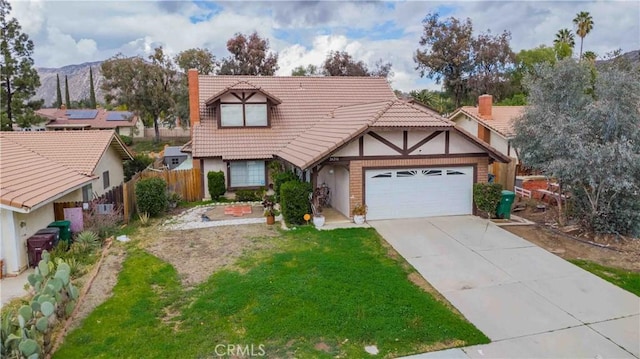 tudor home with a tiled roof, an attached garage, fence, and driveway