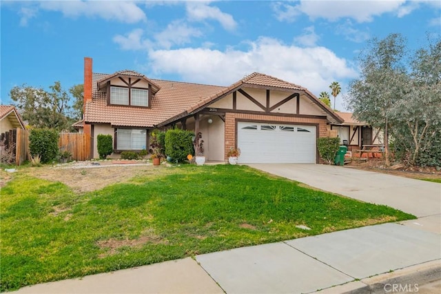 english style home featuring a tile roof, concrete driveway, a front yard, fence, and a garage