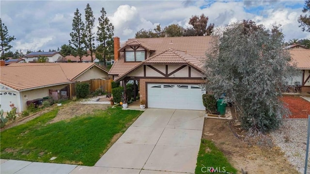 tudor-style house featuring a garage, concrete driveway, a tiled roof, fence, and a front lawn