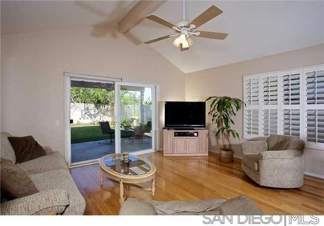 living room featuring beamed ceiling, ceiling fan, high vaulted ceiling, and hardwood / wood-style floors