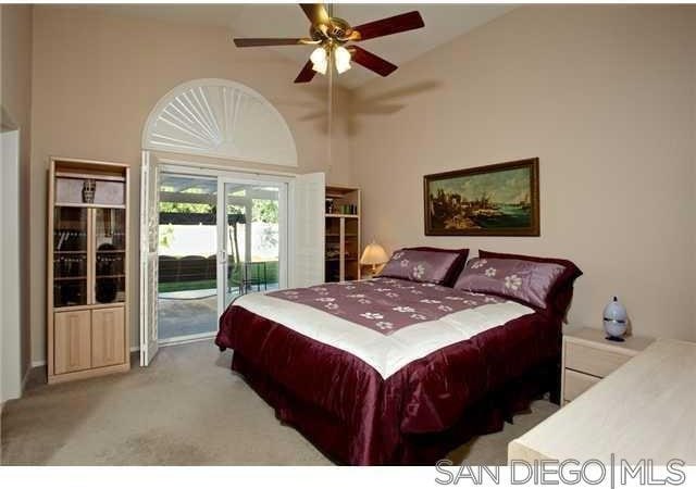 bedroom featuring access to outside, light colored carpet, and ceiling fan