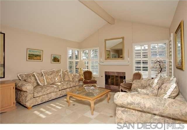 living room with lofted ceiling with beams