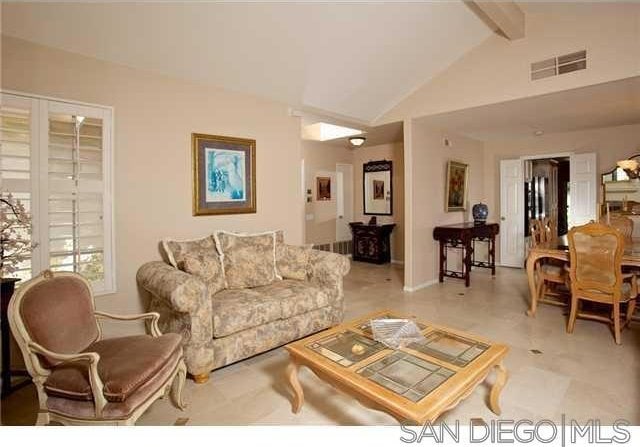 living room featuring lofted ceiling with beams