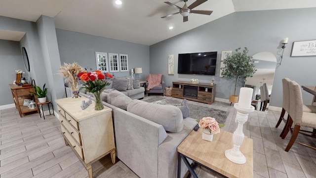 living room with vaulted ceiling, ceiling fan, and light hardwood / wood-style floors