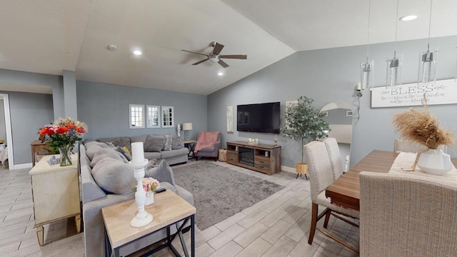 living room featuring ceiling fan and vaulted ceiling