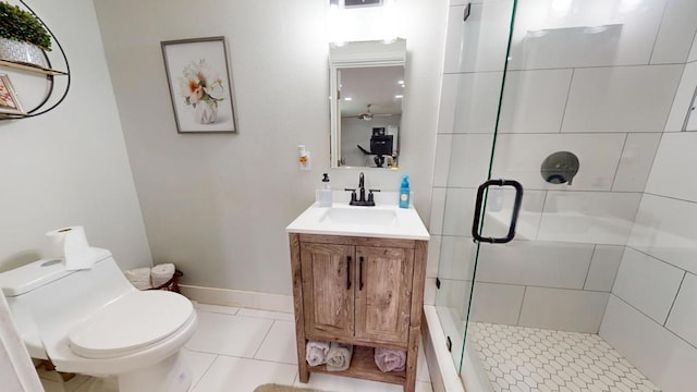 bathroom featuring an enclosed shower, vanity, tile patterned floors, and toilet