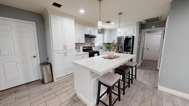 kitchen with black range with gas cooktop, sink, white cabinets, and stainless steel refrigerator with ice dispenser