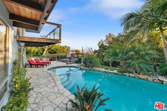 view of swimming pool with a patio area