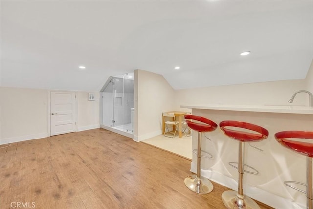 bonus room with light wood-type flooring, baseboards, vaulted ceiling, and recessed lighting