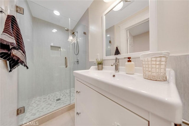 full bath with a shower stall and vanity