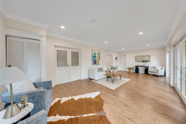 living area featuring french doors, wood finished floors, ornamental molding, and recessed lighting