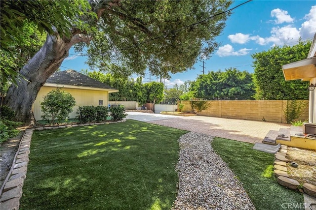 view of yard featuring a patio area and a fenced backyard