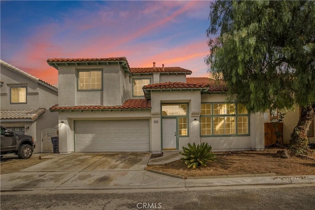 mediterranean / spanish home featuring a garage