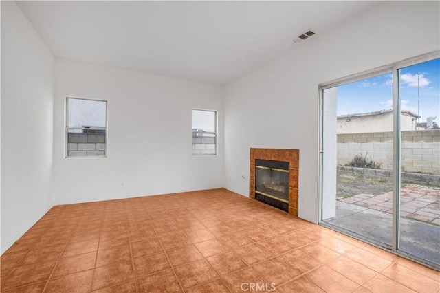 unfurnished living room with a tile fireplace